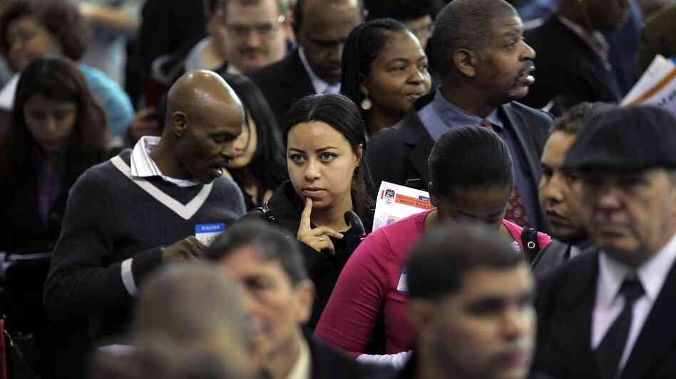 People wait at a job fair in New York City's Queens borough on Thursday. While millions of out-of-work Americans continue to seek employment, others have given up looking.