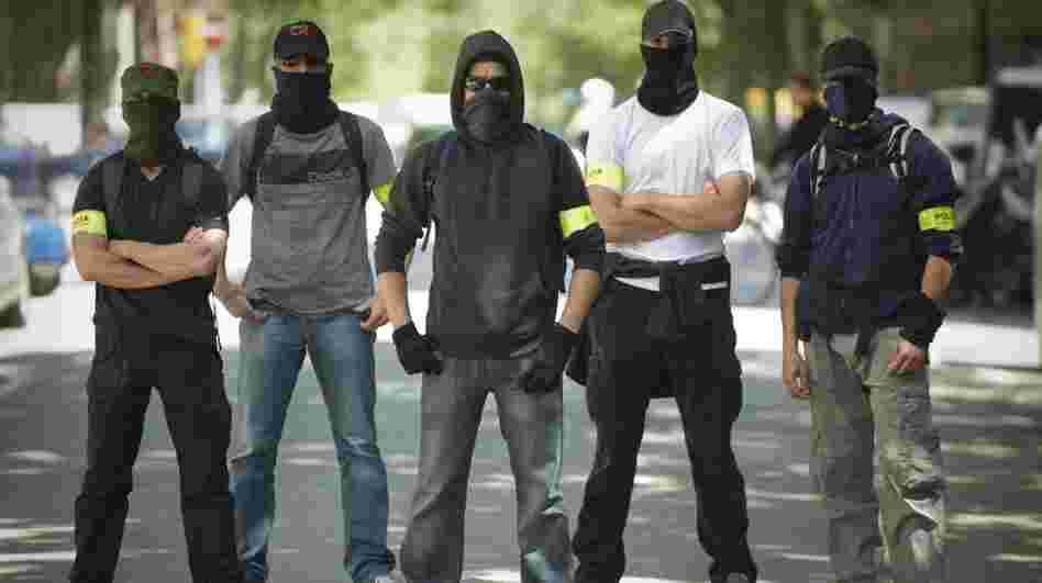 Undercover police stand on a Barcelona street during Thursday's demonstration against austerity cuts. On the same day, the European Central Bank's governing council met there but offered no relief to painful austerity measures. Undercover police stand on a Barcelona street during Thursday's demonstration against austerity cuts. On the same day, the European Central Bank's governing council met there but offered no relief to painful austerity measures.