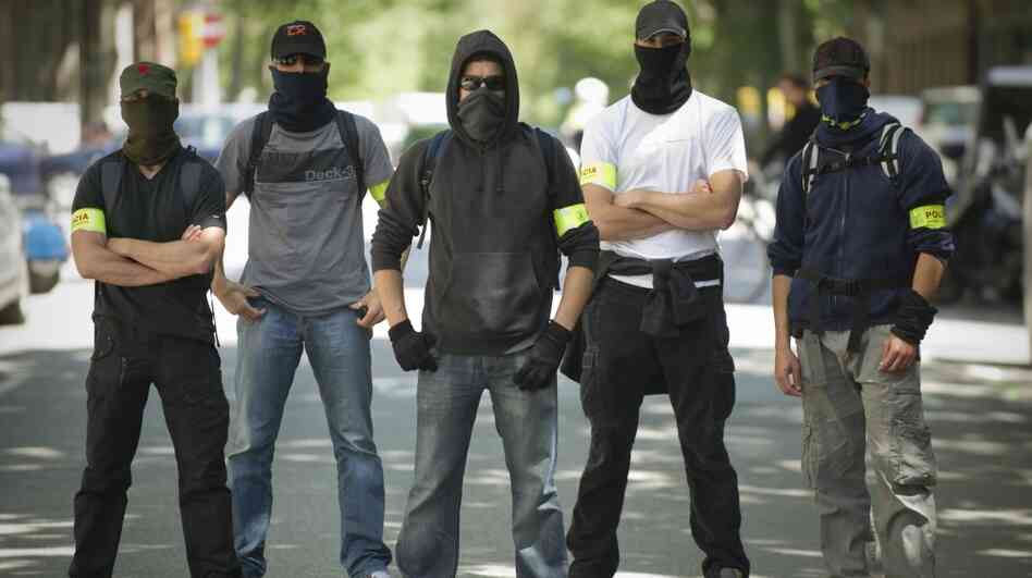 Undercover police stand on a Barcelona street during Thursday's demonstration against austerity cuts. On the same day, the European Central Bank's governing council met there but offered no relief to painful austerity measures. Undercover police stand on a Barcelona street during Thursday's demonstration against austerity cuts. On the same day, the European Central Bank's governing council met there but offered no relief to painful austerity measures.