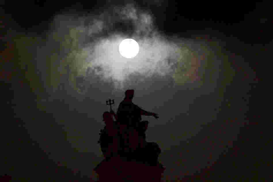The moon is seen over the landmark Chhatrapati Shivaji Terminus in Mumbai, India, on Saturday. 