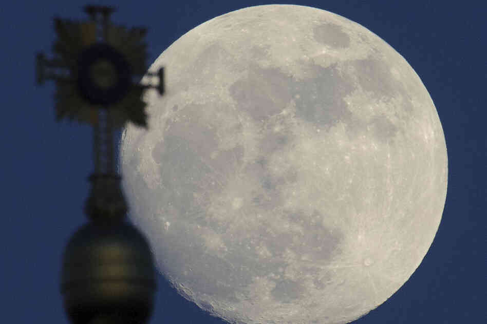 Almost full moon behind the cross of the Frauenkirche (Church of Our Lady) in Dresden, eastern Germany, on May 4, 2012. 
