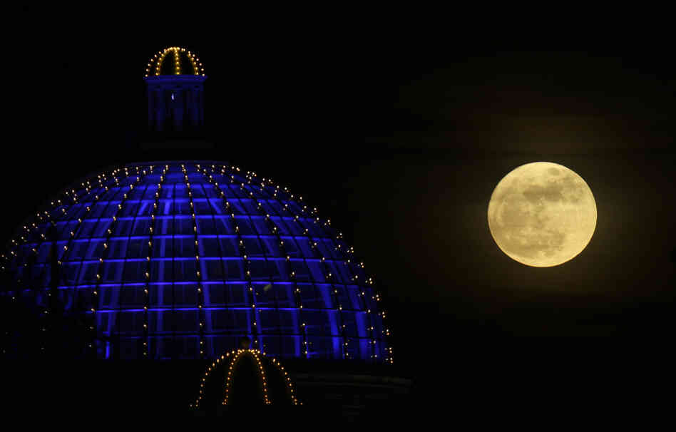 A super moon rises above a shopping center in Manchester, Britain, on March 19, 2011.