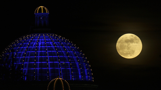 A super moon rises above a shopping center in Manchester, Britain, on March 19, 2011. (AP)