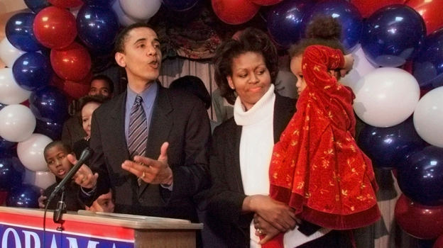 Barack Obama, then a Democratic candidate for a U.S. House seat, delivers his concession speech to supporters, while his wife, Michelle, tends to their daughter, Malia, on March 21, 2000, in Chicago.