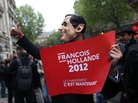 A supporter of French President-elect Francois Hollande wears a mask of outgoing President Nicolas Sarkozy. A supporter of French President-elect Francois Hollande wears a mask of outgoing President Nicolas Sarkozy.