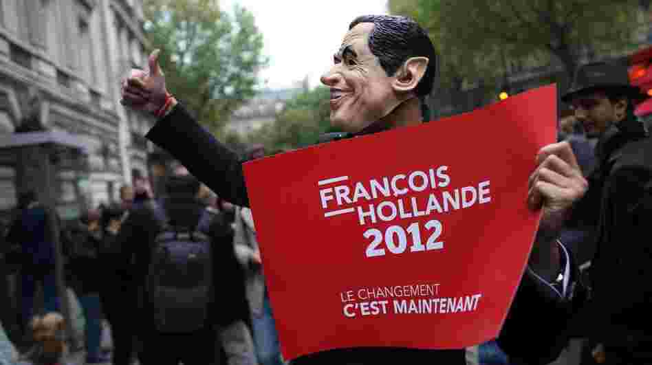 A supporter of French President-elect Francois Hollande wears a mask of outgoing President Nicolas Sarkozy. A supporter of French President-elect Francois Hollande wears a mask of outgoing President Nicolas Sarkozy.