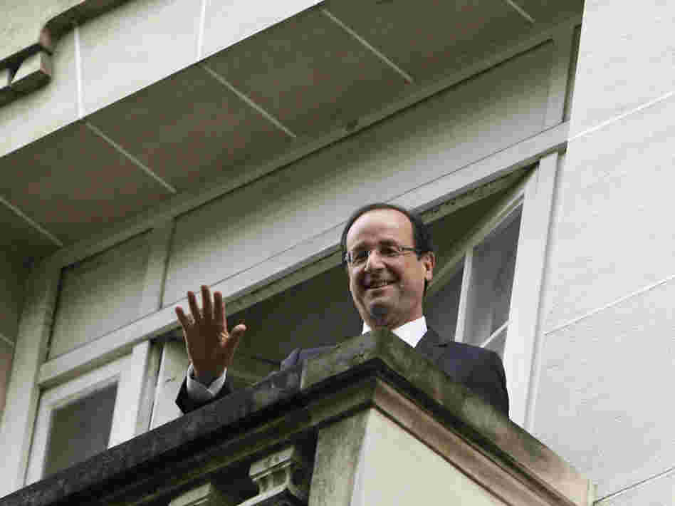 President-elect Francois Hollande waves from a Socialist Party headquarters balcony in Paris Monday May 7, 2012.