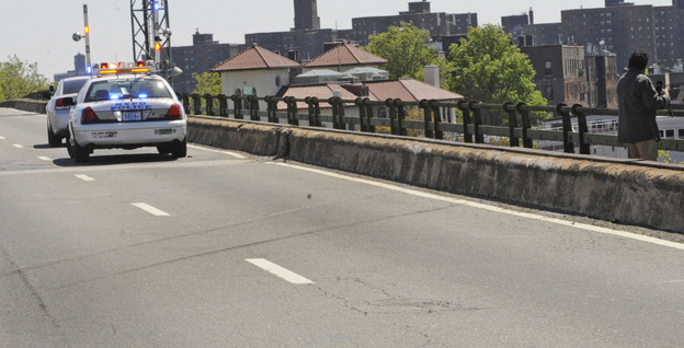 Skid marks left by a van are visible on a highway after a van plunged over both the concrete and iron railing, killing three generations of a Bronx family, in New York.