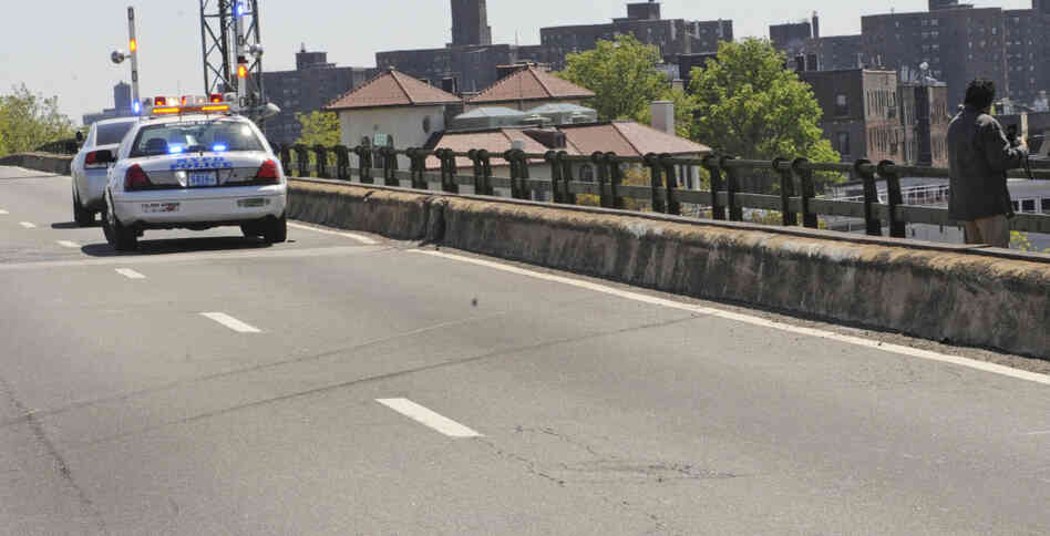 Skid marks left by a van are visible on a highway after a van plunged over both the concrete and iron railing, killing three generations of a Bronx family, in New York.