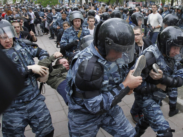 Riot police detain an opposition supporter during an anti-Putin protest in Moscow on Monday. Tens of thousands of people — mostly young Russians — turned out in protest against Putin on Sunday and Monday.