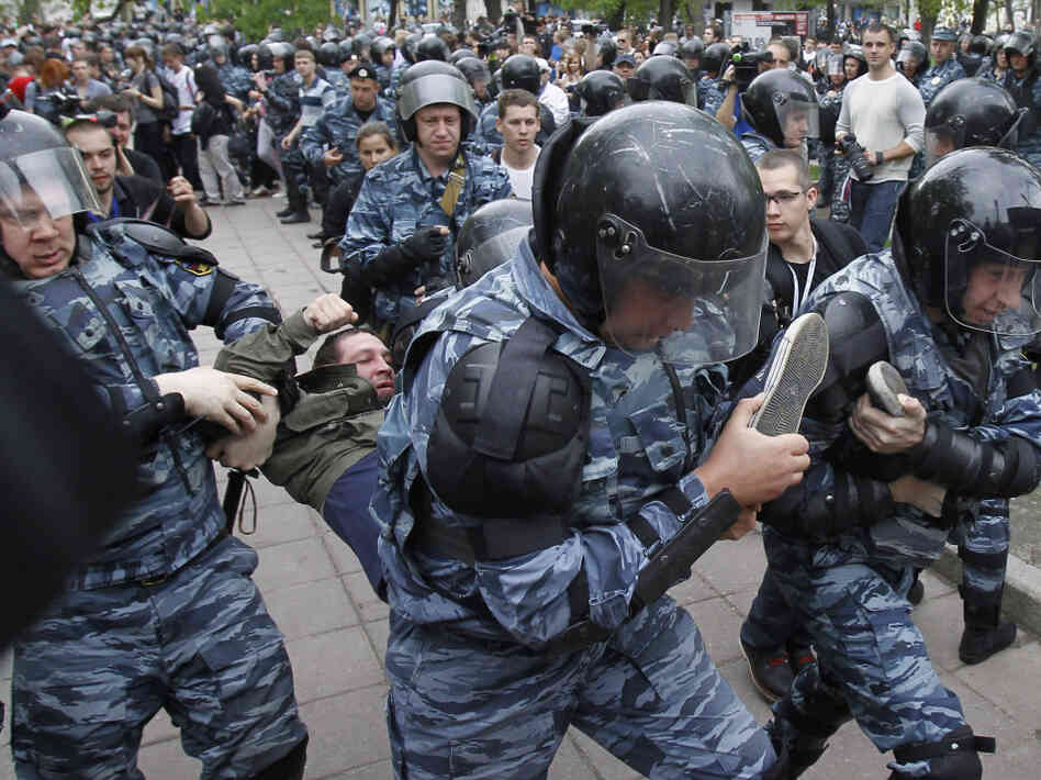Riot police detain an opposition supporter during an anti-Putin protest in Moscow on Monday. Tens of thousands of people — mostly young Russians — turned out in protest against Putin on Sunday and Monday.