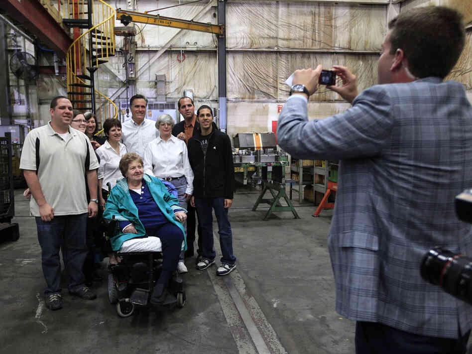Mitt Romney poses with a group of supporters at a Euclid, OH town hall-style meeting where some voters didn't exactly help him keep to his themes. Mitt Romney poses with a group of supporters at a Euclid, OH town hall-style meeting where some voters didn't exactly help him keep to his themes.