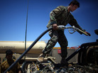 U.S. troops are training Afghan soldiers to take more responsibility in the war against the Taliban. But the Afghans still depend heavily on the Americans. Here, an Afghan solider fills up gas cans with diesel fuel from a U.S. Army tanker in southern Afghanistan. U.S. troops are training Afghan soldiers to take more responsibility in the war against the Taliban. But the Afghans still depend heavily on the Americans. Here, an Afghan solider fills up gas cans with diesel fuel from a U.S. Army tanker in southern Afghanistan.