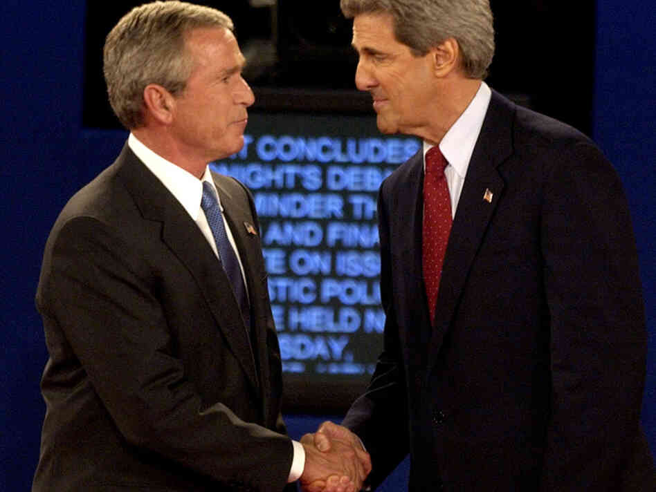 President Bush and then-Democratic presidential nominee John Kerry shake hands at the end of a presidential debate in 2004 in St. Louis. Researchers want to better understand why partisans' views of the facts change in light of their political loyalties.