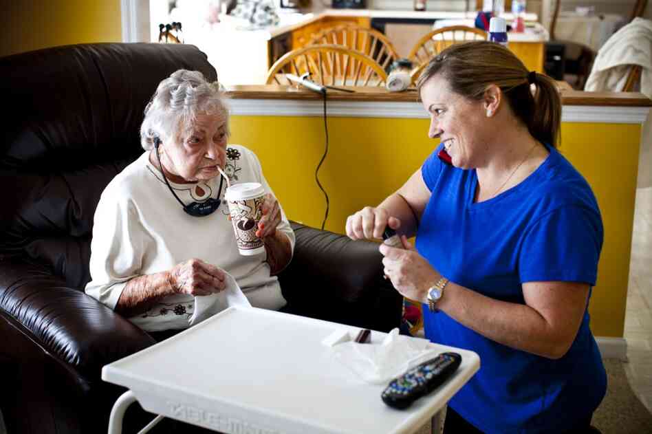 LaDonna talks on the phone with Kelley while helping AnnaBelle with her makeup in her family's living room.