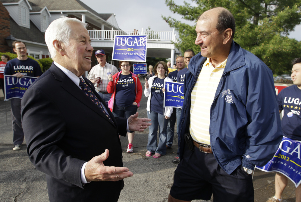 Sen. Richard Lugar talks with Joe Purichia before voting on Tuesday in Greenwood, Ind.