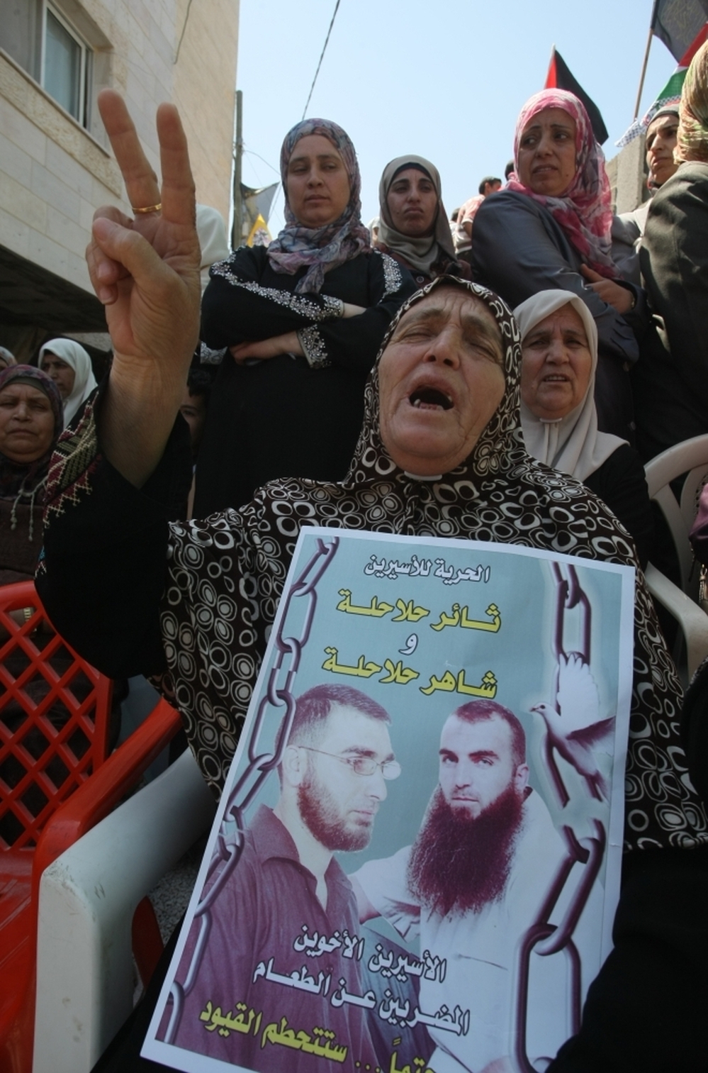 A Palestinian woman holds pictures of jailed relatives during a demonstration in the West Bank city of Hebron on Tuesday, May 8. Palestinians are protesting in solidarity with some 1,500 prisoners on hunger strike who are demanding an end to Israel's practice of detention without trial as well as more frequent family visits, among other issues.