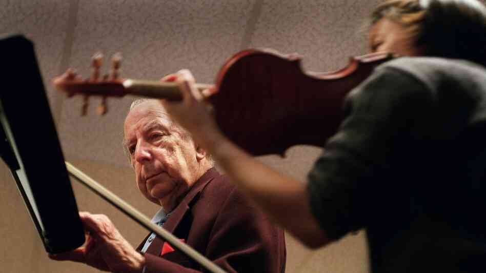 Totenberg teaches student Letitia Hom in his classroom at Boston University. Totenberg made his debut as a soloist with the Warsaw Philharmonic at age 11.