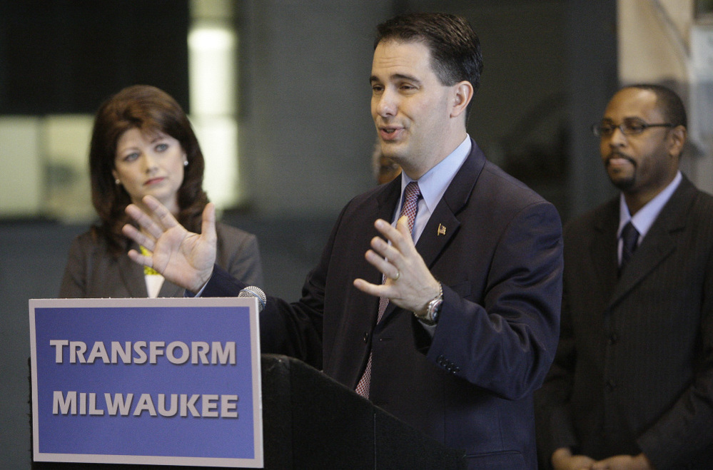 Gov. Scott Walker announces the $100 million "Transform Milwaukee" initiative at Hatco Corp. in Milwaukee on April 30, along with Lt. Gov. Rebecca Kleefisch and Workforce Development Director Reggie Newson. Walker faces a recall election June 5.