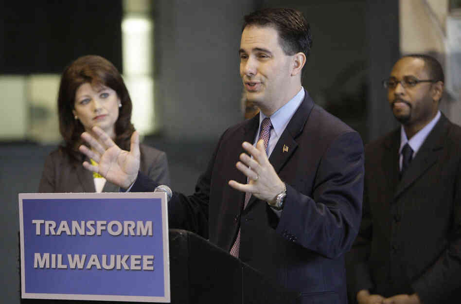 Gov. Scott Walker announces the $100 million "Transform Milwaukee" initiative at Hatco Corp. in Milwaukee on April 30, along with Lt. Gov. Rebecca Kleefisch and Workforce Development Director Reggie Newson. Walker faces a recall election June 5.