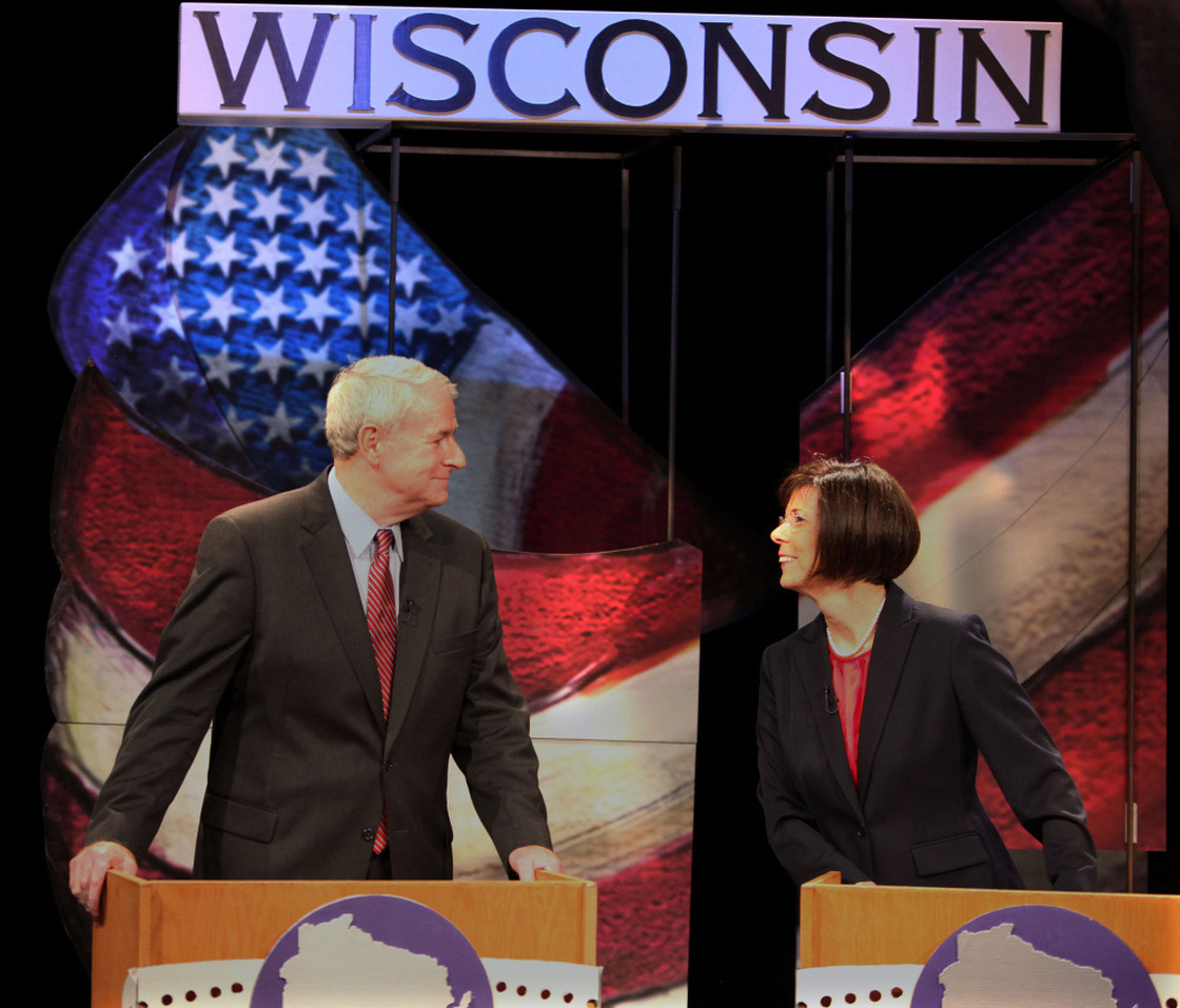 Tom Barrett and Kathleen Falk chat before the start of a live debate for Democratic gubernatorial primary candidates Friday at the Wisconsin Public Television studio in Madison. The front-runners vying for a chance to take on Republican Gov. Scott Walker in a June recall election bashed the governor during the debate. Not pictured are fellow candidates Doug La Follette and Kathleen Vinehout.