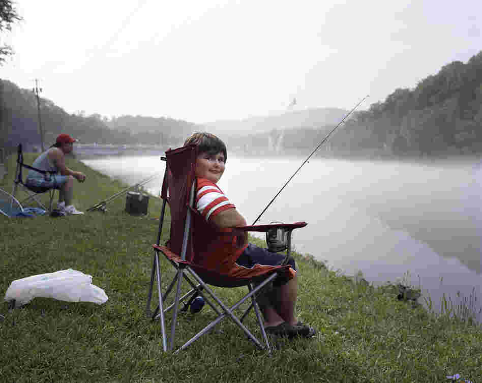 Elizabethton, Tenn., 2007. And I loved this boy's expression and posture and how it played off the image of his father behind him.