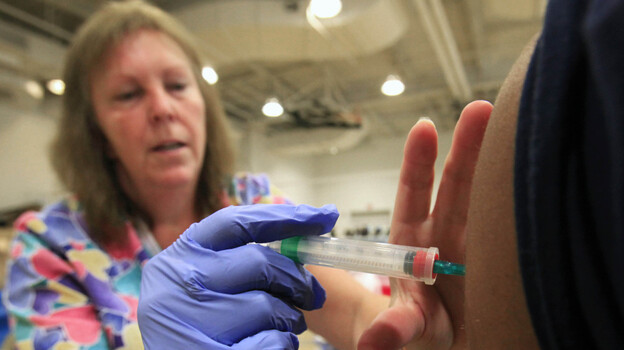 Nurse Susan Peel gives a whooping cough vaccination to a high school student in Sacramento, Calif. The whooping cough vaccine given to babies and toddlers loses much of its effectiveness after by the time people reach their teens and early adulthood.