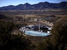 Trucks, water tanks and fracking equipment amassed on a gas pad near the town of Silt and the Grand Hogback Mountain Range. Trucks, water tanks and fracking equipment amassed on a gas pad near the town of Silt and the Grand Hogback Mountain Range.