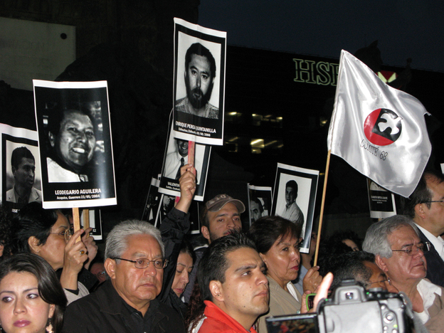Mexicans hold up posters of journalists who have been killed in recent years, at a recent vigil in Mexico City.