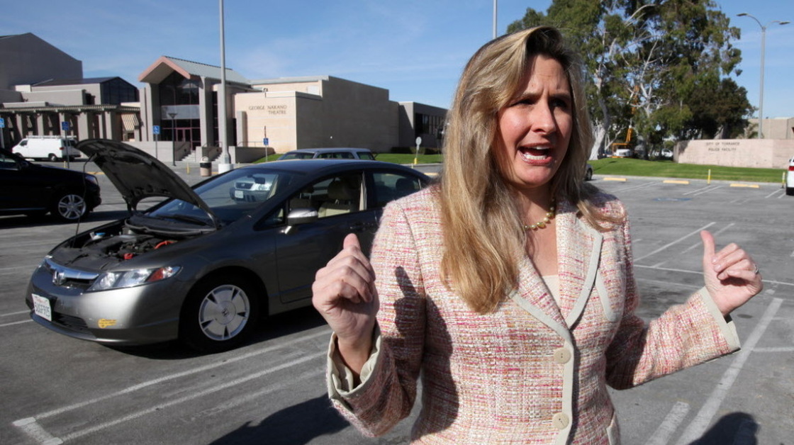 Heather Peters and her 2006 Honda Civic hybrid. She went to court over its disappointing mileage. 