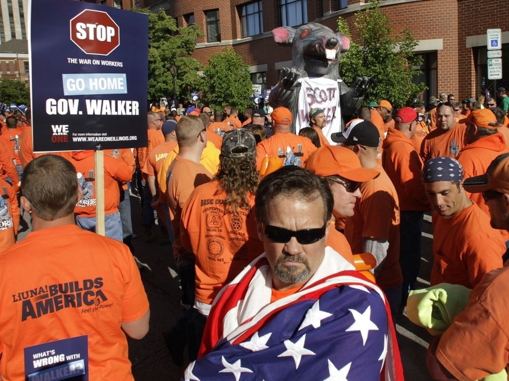 Protesters march outside the Abraham Lincoln Presidential Hotel where Wisconsin Gov. Scott Walker is speaking to the Illinois Chamber of Commerce on April 17 in Springfield, Ill. Walker faces Democrat Tom Barrett in a recall election June 5. The events in the state over the next four weeks could be a sign of where the U.S. is headed in the months ahea