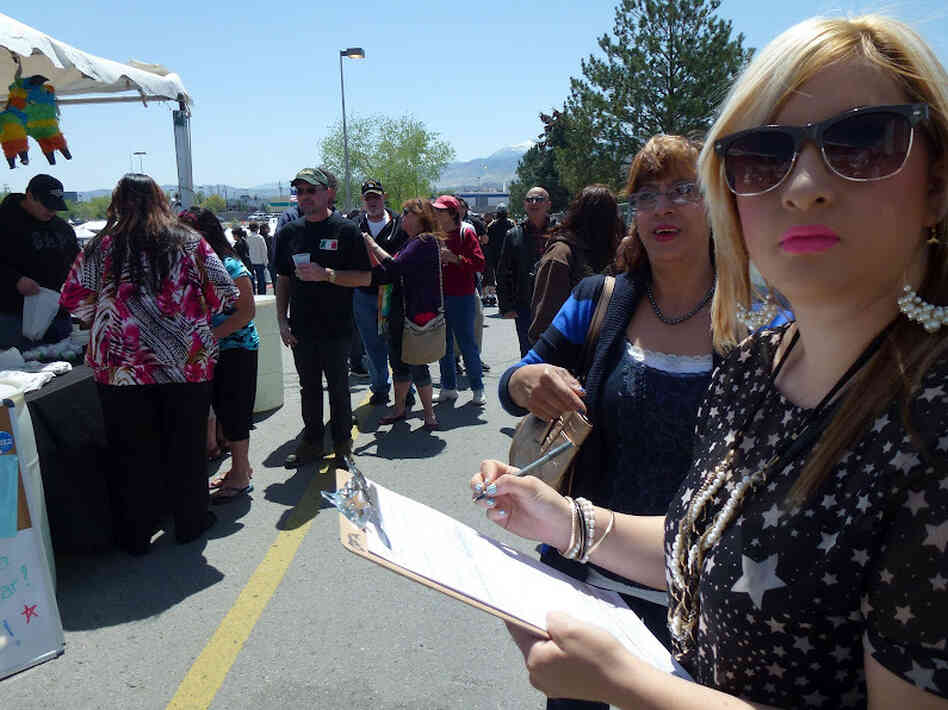 Caroline Maya, a 21-year-old college student, registers to vote for the first time at the Latinos for Obama booth outside the Grand Sierra Casino in Reno, Nev., Saturday.
