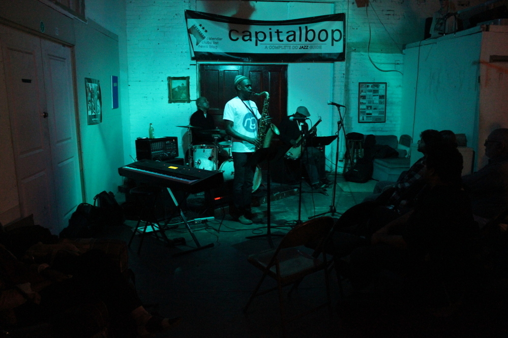 Mad Curious, with drummer Lenny Robinson, saxophonist Brian Settles and bassist Tarus Mateen, performs at a Capitalbop house show.
