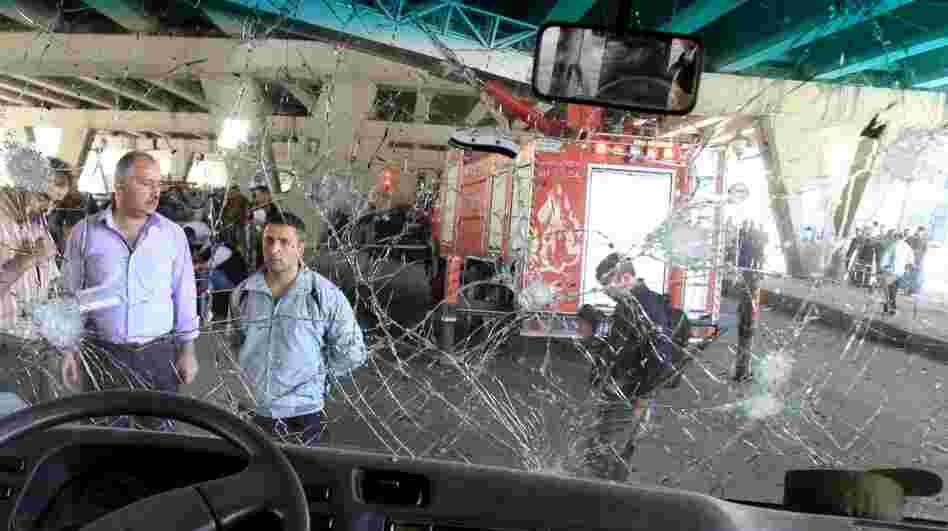 Syrians appear behind the damaged windshield of a minibus as they inspect the site of a blast in the central Midan district of Damascus last month. A new jihadist organization in Syria claimed responsibility for the attack. Syrians appear behind the damaged windshield of a minibus as they inspect the site of a blast in the central Midan district of Damascus last month. A new jihadist organization in Syria claimed responsibility for the attack.