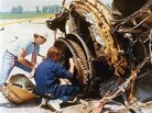 National Transportation Safety Board investigators check over the burnt remains of a jet engine from the DC-10. National Transportation Safety Board investigators check over the burnt remains of a jet engine from the DC-10.