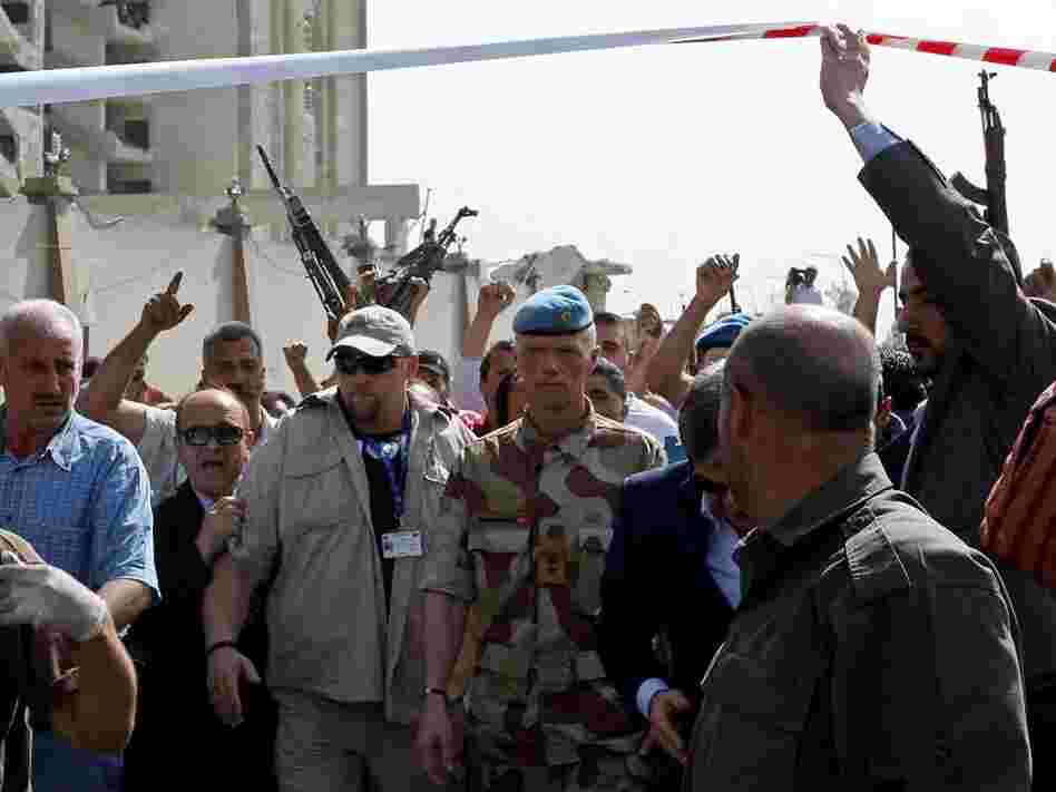 Norwegian Maj. Gen. Robert Mood (center), head of the U.N. observers mission in Syria, arrives to inspect the site of twin blasts.