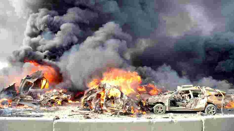 A pair of powerful bombs killed more than 50 people on the outskirts of Damascus on Thursday. This photo released by the official Syrian news agency SANA shows the aftermath. The blasts were the latest blow to a collapsing peace plan.