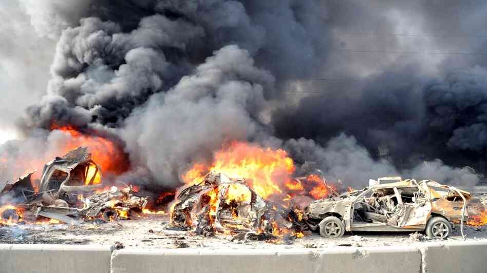 A pair of powerful bombs killed more than 50 people on the outskirts of Damascus on Thursday. This photo released by the official Syrian news agency SANA shows the aftermath. The blasts were the latest blow to a collapsing peace plan.