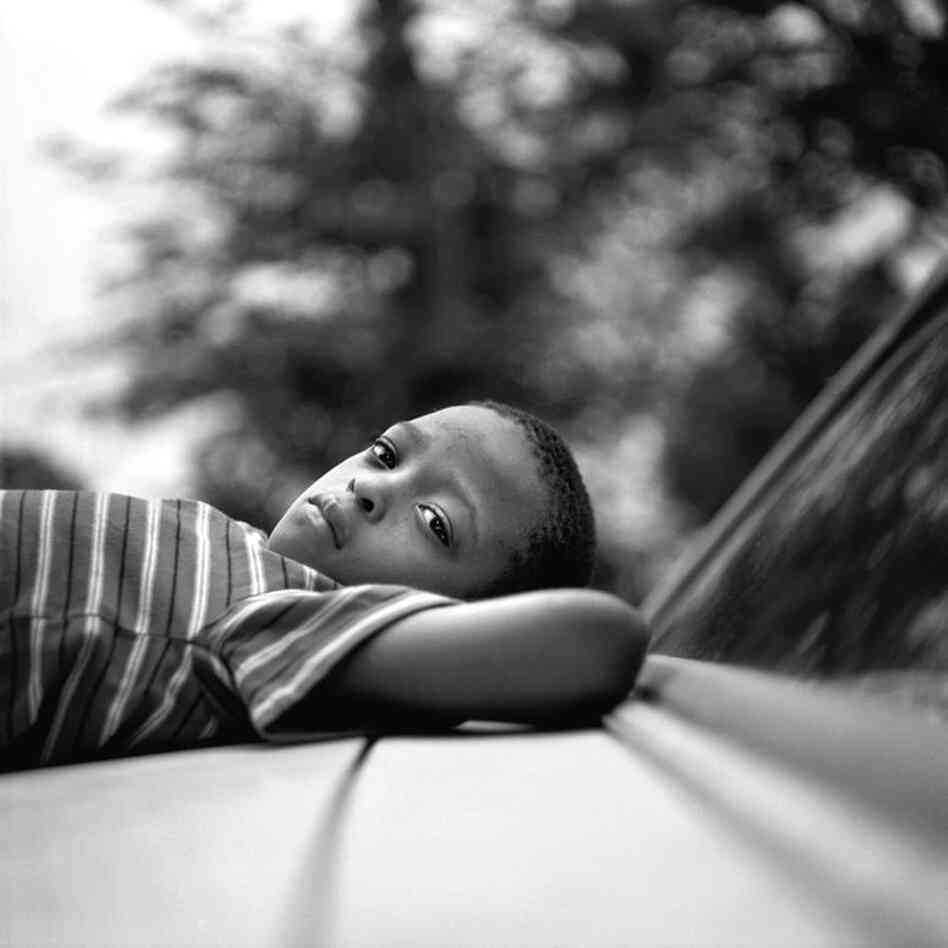 Reclining on a car in Duncan, June 2009.