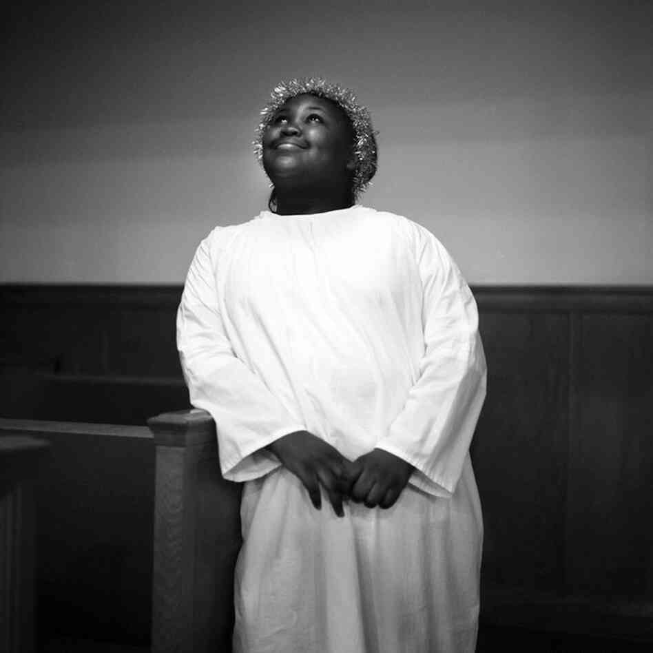 Dressed as an angel, a young girl poses for a portrait after the First Baptist Church of Mound Bayou's Christmas Eve celebration, 2010.