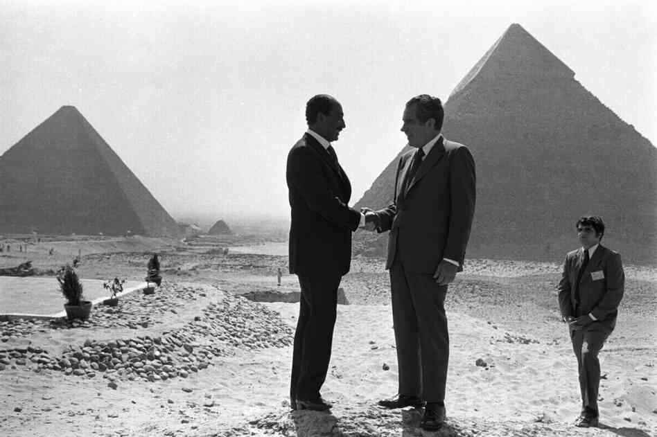 Presidents Anwar Sadat and Richard Nixon shake hands in front of the pyramids at Giza, near Cairo, June 1974.
