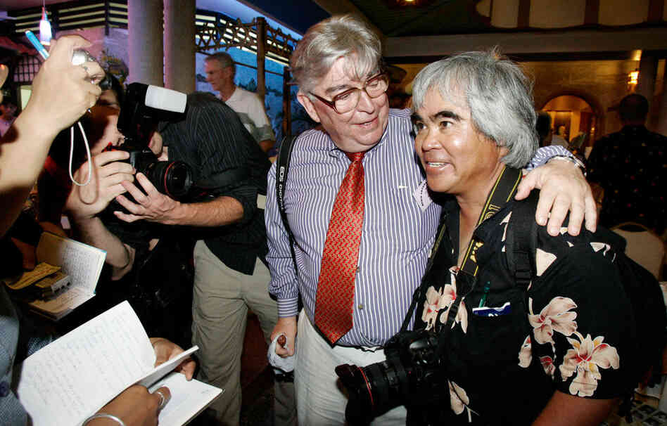 Faas (left),with Vietnamese-American photographer Nick Ut, both Pulitzer Prize winners who covered the Vietnam War, share a moment during a reunion party in Ho Chi Minh City, Vietnam, marking the 30th anniversary of the war's end, April 2005. 