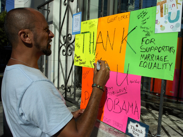 Kelly Rivera Hart of San Francisco, California, adds his thoughts to a "thank you" card for President Obama posted at the intersection of Castro and 18th Streets in San Francisco on Wednesday, May 9. Obama spoke earlier in the day of his personal beliefs on gay marriage.