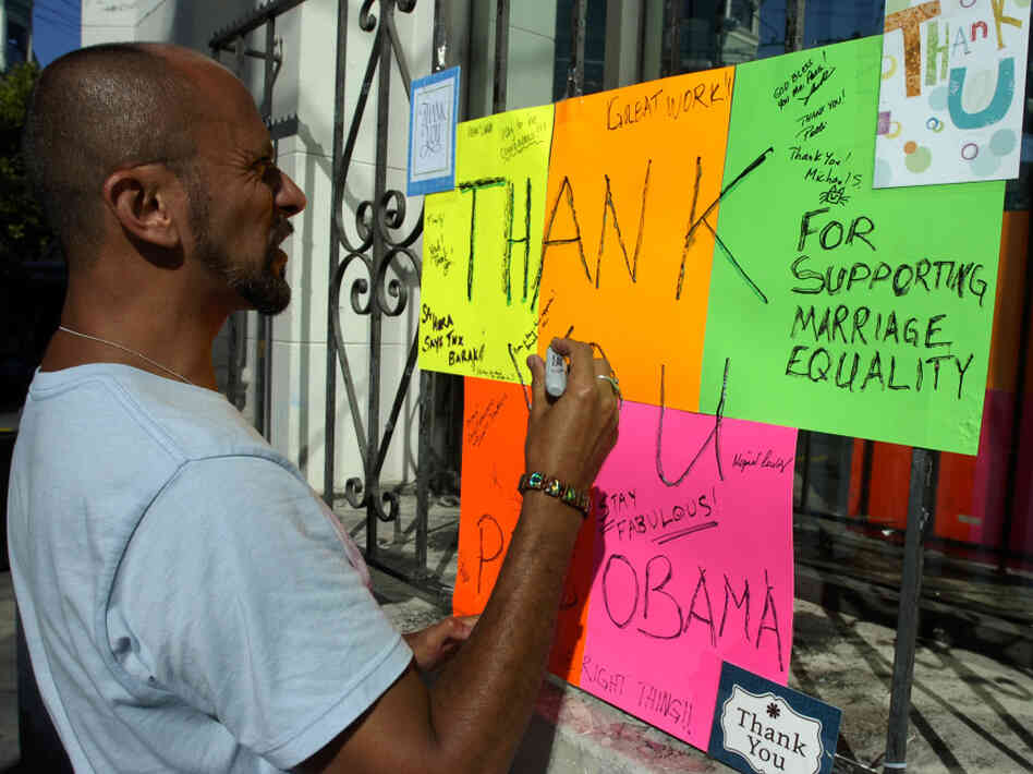 Kelly Rivera Hart of San Francisco, California, adds his thoughts to a "thank you" card for President Obama posted at the intersection of Castro and 18th Streets in San Francisco on Wednesday, May 9. Obama spoke earlier in the day of his personal beliefs on gay marriage.