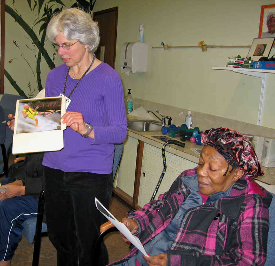 Linda White (left) leads a session based on a program called TimeSlips at a Seattle senior center. The idea is to show photos to people with memory loss to help them make up a story. Linda White (left) leads a session based on a program called TimeSlips at a Seattle senior center. The idea is to show photos to people with memory loss to help them make up a story.