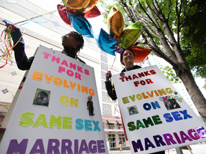 Marriage equality supporters Teri McClain (left) and Mary Beth Brotski demonstrate Thursday in Seattle. Marriage equality supporters Teri McClain (left) and Mary Beth Brotski demonstrate Thursday in Seattle.