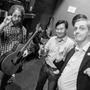 Jonathan Coulton, left, Art Chung and John Chaneski like to start each show by throwing up some horns backstage at The Bell House in Brooklyn, NY.