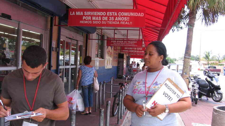Melli Romero (right), a canvasser with the National Council of La Raza, works outside La Mia Supermarket in Miami on May 9. Melli Romero (right), a canvasser with the National Council of La Raza, works outside La Mia Supermarket in Miami on May 9.