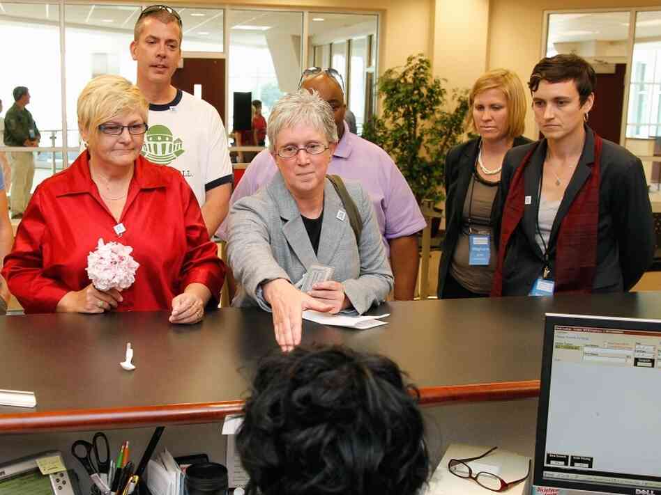 In protest of state law, a same-sex couple attempts to obtain a marriage license at the Forsyth County Register of Deeds office in Winston-Salem, N.C., Thursday, May 10.