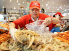 A fishmonger prepares her wares at the Sydney Fish Market. A fishmonger prepares her wares at the Sydney Fish Market.